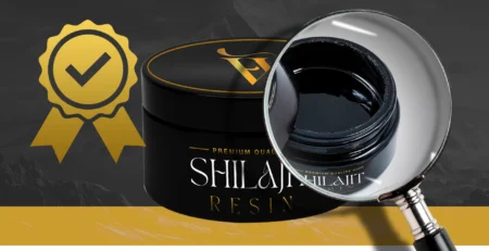 Premium quality Shilajit resin in a black jar with a magnifying glass highlighting its texture, ensuring authenticity.